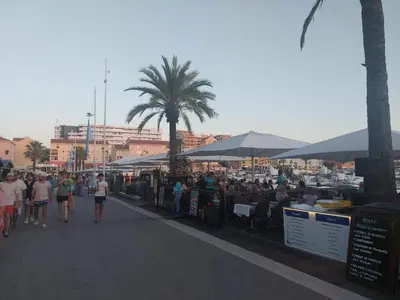 a crowd of people walking down a street with tents at Impervila 201 in Vilamoura
