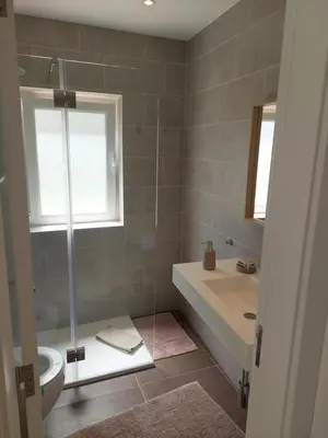 a bathroom with a shower and a tub and a sink at Impervila 201 in Vilamoura