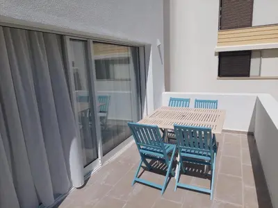 a patio with a table and chairs on a balcony at Impervila 201 in Vilamoura