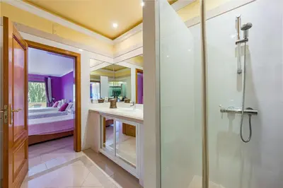 a bathroom with a shower and a sink and a tub at Villa Casa do Monte in Albufeira
