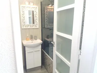 a bathroom with a sink and a mirror at Studio Praia de Quarteira in Quarteira