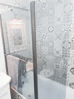 a shower with a glass door in a bathroom at Studio Praia de Quarteira in Quarteira
