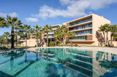 a swimming pool in front of a building at TAC - Salgados Beach Prime Pool Resort in Guia