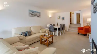 a living room with a couch and a table at Townhouse Farah in Vale do Lobo