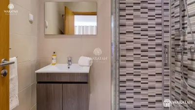 a bathroom with a sink and a shower at Townhouse Farah in Vale do Lobo