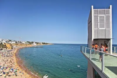 a view of a beach with people on a building at Blue Sea in Albufeira