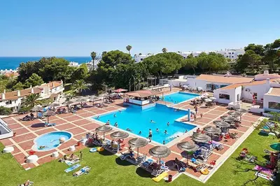an overhead view of a swimming pool with people sitting around it at Blue Sea in Albufeira