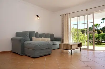 a living room with a couch and a coffee table at Jardins da Galé Beach House in Albufeira