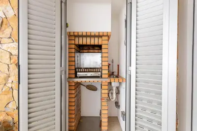 a hallway with a shelf with a microwave on it at Glamour Apartment With Pool in Albufeira
