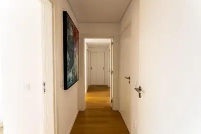 a hallway with white walls and wooden floors at Glamour Apartment With Pool in Albufeira