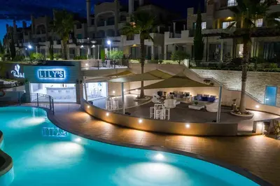 a pool at a hotel at night at Vilamoura Pine Hills Luxury Apartment in Quarteira