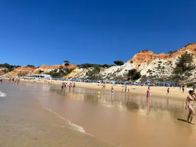 a group of people standing on a beach at Varanda para o Mar in Albufeira