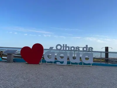 a heart sitting next to a sign on the beach at Varanda para o Mar in Albufeira