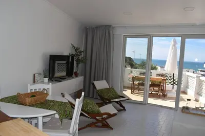 a living room with a view of the ocean at Varanda para o Mar in Albufeira