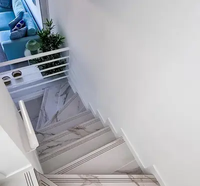 a stairway with white ceilings and a plant at FLH Albufeira Ocean View House with Garden & Pool in Albufeira