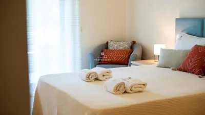 a bedroom with a bed with towels on it at Apartamento do Pinhal - By Dalma Portuguesa in Albufeira