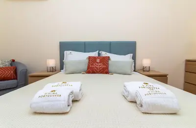 a bedroom with a bed with towels on it at Apartamento do Pinhal - By Dalma Portuguesa in Albufeira