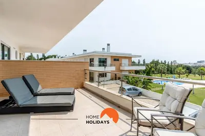 a balcony with two chairs and a view of a house at #160 V3 Vila Branca 92 by Home Holidays in Albufeira