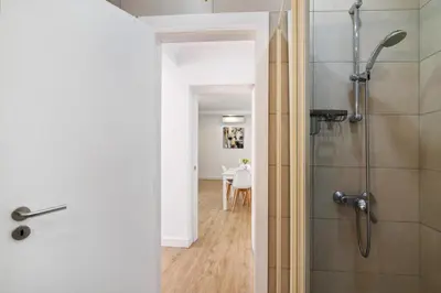 a bathroom with a shower with a glass door at Moderno e renovado T2 in Quarteira