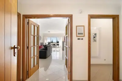 a hallway with a door open to a living room at Vilamoura Marina in Vilamoura
