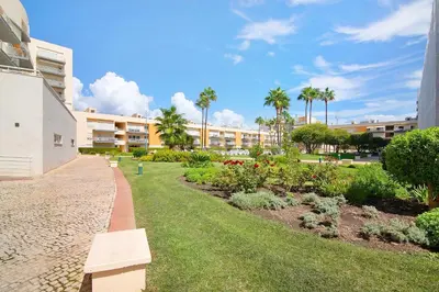 a park with a bench next to a building at Vilamoura Marina in Vilamoura