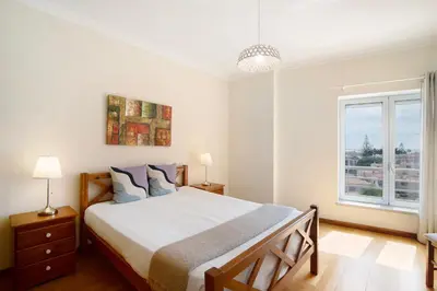 a bedroom with a large bed and a desk at Vilamoura Marina in Vilamoura