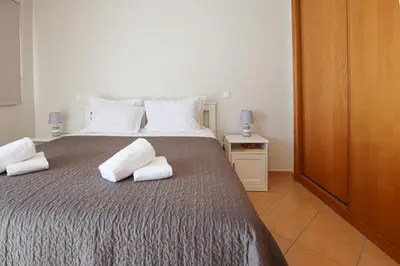 a bedroom with a bed with two pillows on it at Apart ALGARVE - Piscina - BY BEDZY in Albufeira