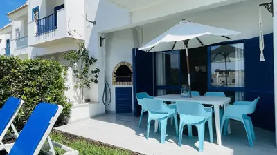 a table and chairs with an umbrella on a patio at Jardim da Oura by Check-in Portugal in Albufeira
