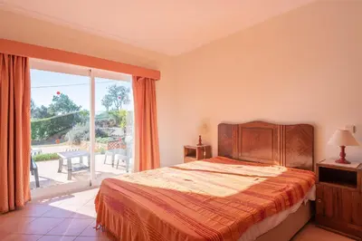 a bedroom with a bed and a large window at Villa Agua by Gabi Miguel in Albufeira