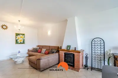 a living room with a couch and a fireplace at #158 T3 Panorama C by Home Holidays in Albufeira