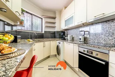 a kitchen with white cabinets and a dishwasher at #158 T3 Panorama C by Home Holidays in Albufeira