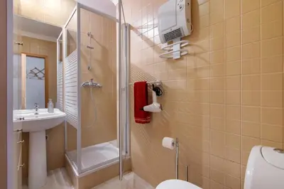 a bathroom with a shower and a toilet and a sink at T2 Encosta São José by Gabi Miguel in Guia