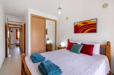 a bedroom with a bed with two towels on it at T2 Encosta São José by Gabi Miguel in Guia