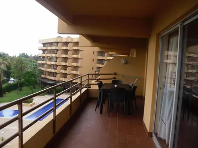 a balcony of a building with a table and chairs at Aparthotel Dom Pedro Portobelo in Vilamoura