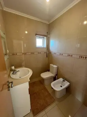 a bathroom with a toilet and a sink at Apartamento Falésia c/ Piscina in Albufeira
