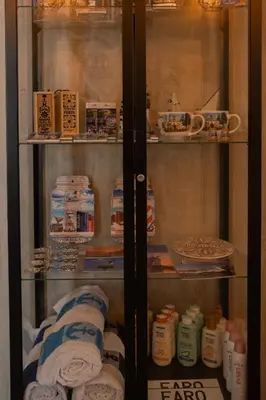 a glass cabinet with towels and other items in it at Ria Formosa Guest House in Faro