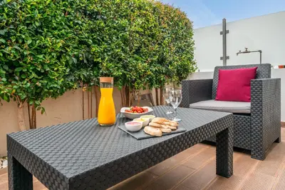 a table with a plate of food and a vase at Sunshine Holiday House in Quarteira