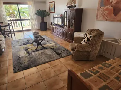 a living room with a dog sitting on a table at Albufeira Traditional Apartments IN VILLA in Albufeira