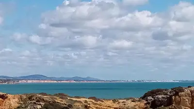 a view of the ocean from a rocky beach at Albufeira Traditional Apartments IN VILLA in Albufeira