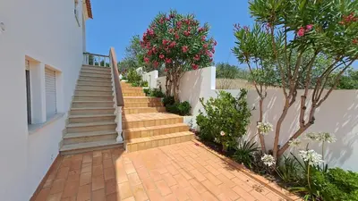 a staircase leading up to a house with flowers at Albufeira Traditional Apartments IN VILLA in Albufeira