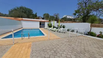 a swimming pool in the backyard of a house at Albufeira Traditional Apartments IN VILLA in Albufeira