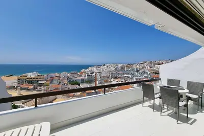 a balcony with chairs and a view of the ocean at Paradise full océan in Albufeira
