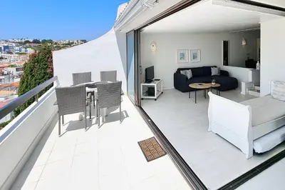 a balcony with a couch and a table and chairs at Paradise full océan in Albufeira