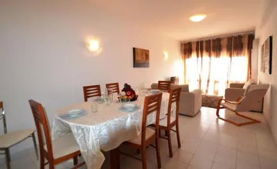 a dining room with a table and chairs at T3 Olhos de Água in Albufeira