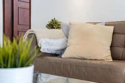 a pillow on a couch with a christmas ornament at Traditional 3 bedroom villa with great pool in the heart of Vale do Lobo in Vale do Lobo