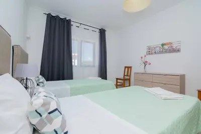 a bedroom with two beds and a window at Avo Isabel by Innkeeper in Guia