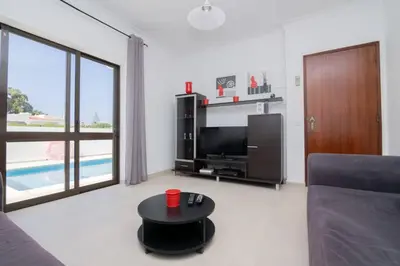 a living room with a couch and a table at Avo Isabel by Innkeeper in Guia