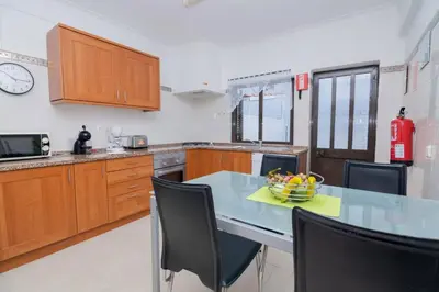 a kitchen with a table with a bowl of fruit on it at Avo Isabel by Innkeeper in Guia