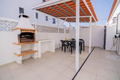 a patio with a table and a grill at Avo Vitoria by Innkeeper in Guia