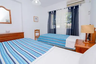 a bedroom with two beds and a mirror at Galé Catia by Innkeeper in Guia